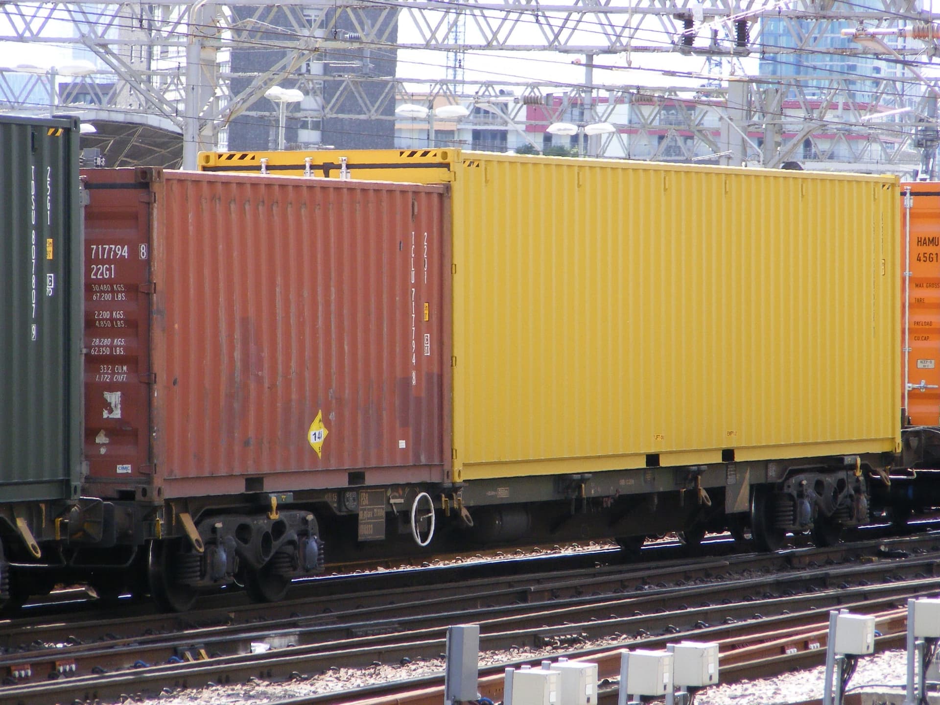 A yellow 40-foot high cube container on a trailer