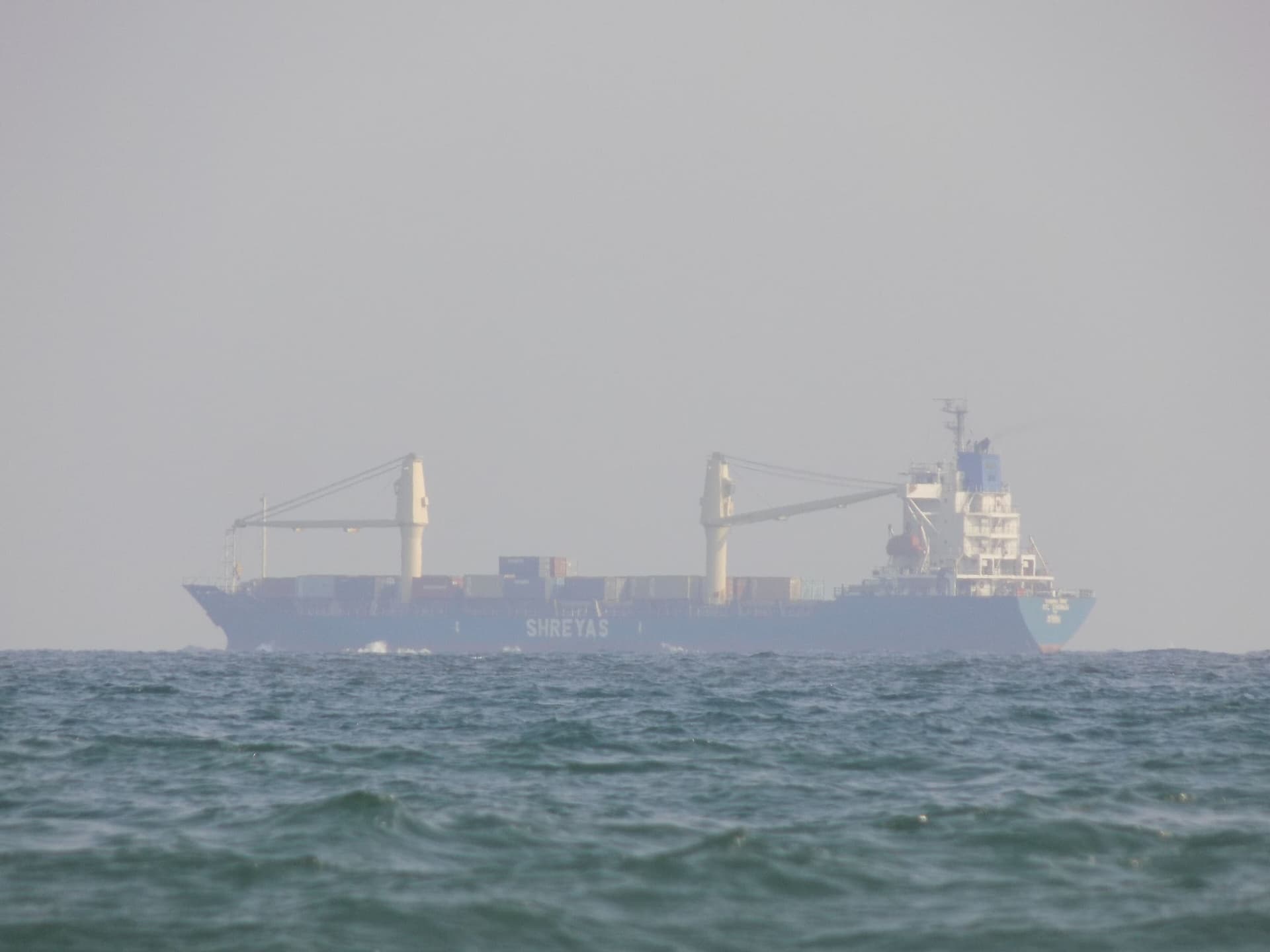 A container ship loaded with boxes under way