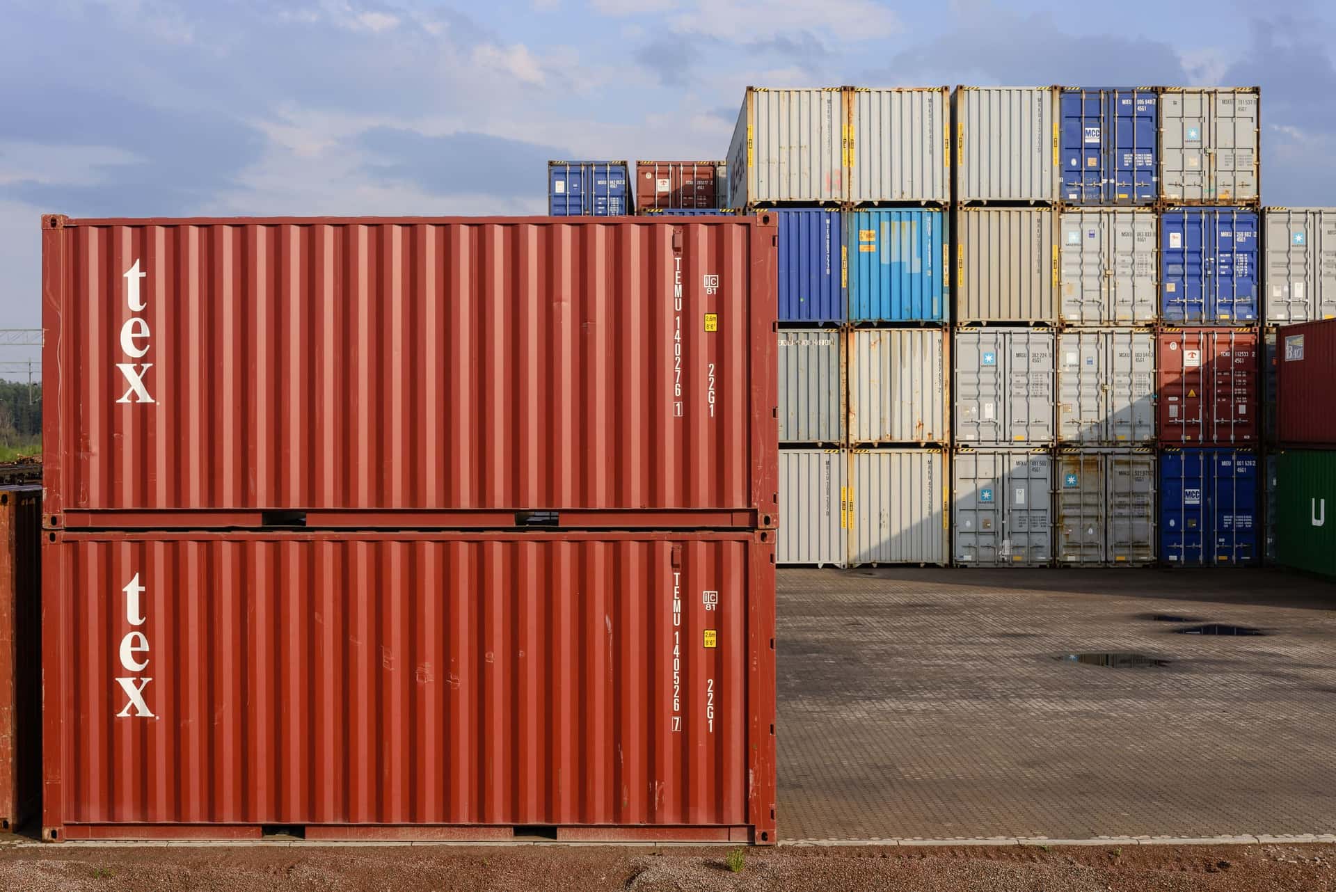 Two stacked 20-foot dry containers in evening light at a container terminal in Sweden
